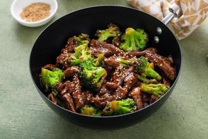 Beef and broccoli stir fry in a small wok photo