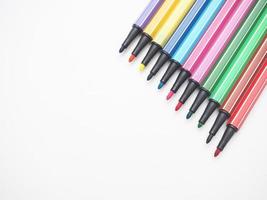 Close up color pen different array on white isolated top view copy space photo