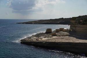 saint peter pools Malta rock formation hole on rocks photo