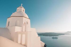 Landscape with greek bell tower, Santorini Island, Greece. Beautiful sea view with cruise ship and volcano. Wonderful travel landscape, summer vacation background. White and blue architecture photo