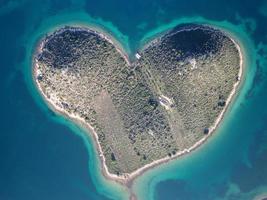 Aerial drone view of Galesnjak the Island of Love in Croatia with beautiful blue turquoise sea water. Heart shaped Island. Travel and holidays destination. Amazing tourism in Croatia Islands. photo
