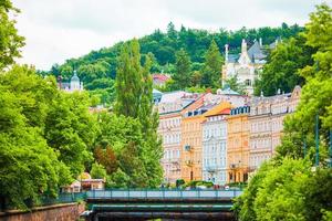 Colorful hotels and traditional buildings on sunny town of Karlovy Vary. The most visited spa town in the Czech Republic. photo