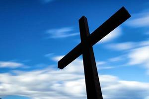 Cross silhouette and the clouds photo