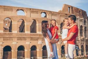 Happy family in Rome over Coliseum background. photo