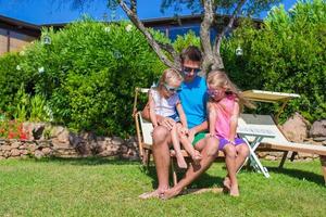 Father and kids at tropical beach vacation having fun outdoor photo