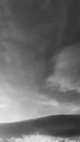 black-white picture vertically, dark sky gray clouds above top view sun, with landscape nature background concept. photo