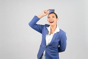 Young beautiful woman in formal clothing for officer with credit card photo