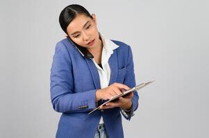 Young beautiful woman in formal clothing for officer use smartphone posture photo