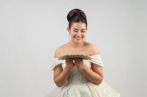 Young asian beautiful bride holding dollar bills in hand photo