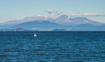 The scenery view of Tongariro national park view from lake Taupo the largest fresh water lake in New Zealand. photo