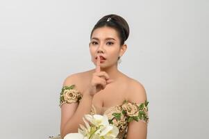 Young asian beautiful bride with orchid bouquet on white background photo