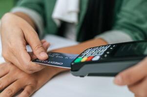 Young businesswoman paying order having contactless payment with cardit card photo