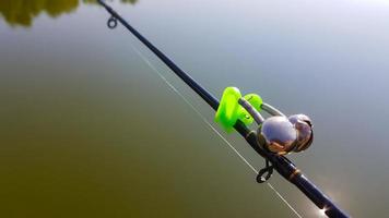 Swing fishing. Rods for carp fishing with a signaling close-up. Kind of pod. Fishing for carp on the background of the lake. The fisherman catches carp. photo