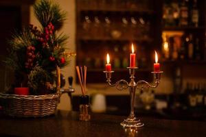 Old candlestick holder in front of a dark red background photo