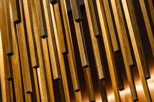 texture of wooden sticks hang from the ceiling at outdoor constructions photo