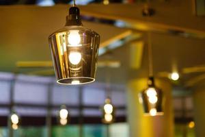 interior of restaurant with big lamps in golden light photo