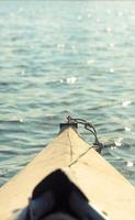 Close up front of boat and shimmering water concept photo