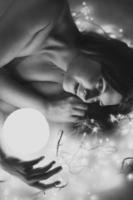 Close up happy lady with magic ball monochrome portrait picture photo