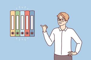 Man office worker points finger at multicolored folders for documents. Guy in business clothes gives advice on finding reports or recommends system for storing financial papers. Flat vector image