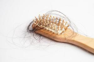 Hair loss fall with comb brush isolated on white background. photo