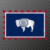 Postage stamp with Wyoming state grunge flag. Vector illustration.