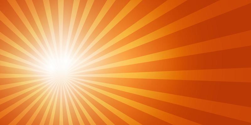 Bright sun on the left side of the sky with sun rays and lens flares in a bright orange sky. Copy space