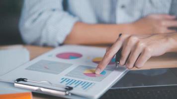 data analyst read business statistics chart reports, to analyze and improve corporate strategy, manage financial and marketing documents, update annual budget accounts, company growth data. photo