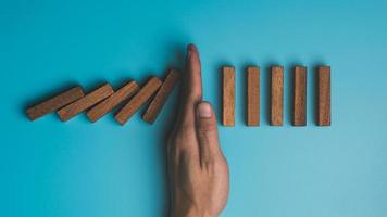 Human hands and wooden blocks represent protection and protection of safety,concept of insurance management planning To ensure both health and financial safety,Property and Family Risk Reduction photo