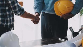Construction and structure concept of Engineer or architect meeting for project working with partner and engineering tools on model building and blueprint in working site, contract for both companies. video