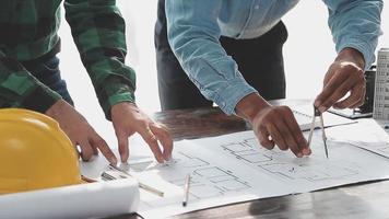 Two business man construction site engineer. Engineering objects on workplace with partners interacting on background video