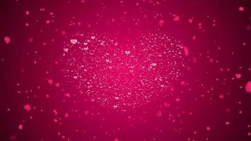 San Valentino giorno rosso rosa animazione con luminosa cuore particella nel il centro tremolante e dissolvenza particella video