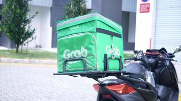 Grab food delivery service logo bag on motor scooter video
