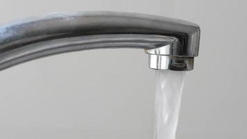 Close up of water streaming out of faucet video