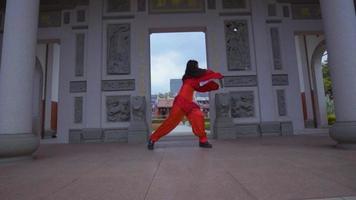 A Chinese Warrior with a red dress practicing the sword for the next battle video