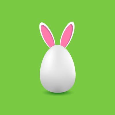 White egg with rabbit ears on a green background