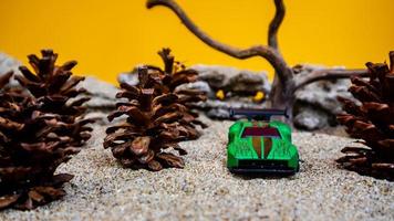 Minahasa, Indonesia  saturday, December 2022, a toy car among the pinecones photo