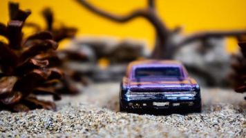 Minahasa, Indonesia  saturday, December 2022, a toy car among the pinecones photo