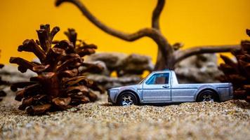 Minahasa, Indonesia  December 2022, the toy car among the pine cones photo