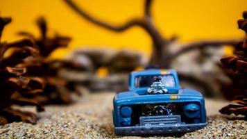 Minahasa, Indonesia  saturday, December 2022, a toy car among the pinecones photo