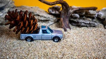 toy car hauling pinecones on an orange background photo