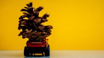 Minahasa, Indonesia  December 2022, the toy car transporting pinecones photo