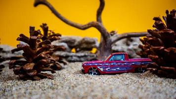 Minahasa, Indonesia December 2022, the toy car among the pine cones photo