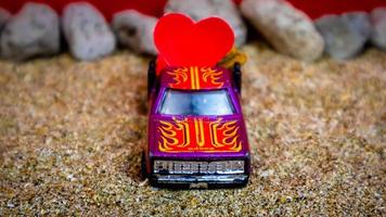 Minahasa, Indonesia December 2022, the toy cars transporting hearts photo