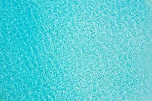 Aerial view of sea surface. Top view of transparent turquoise ocean water surface. Clean nature environment, amazing ecology concept. Sea ocean water, bright blue. Peaceful nature photo