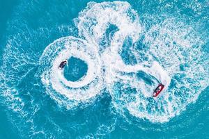 Aerial photo of water sport in Maldives. Landscape seascape aerial view over Maldives atoll sandbank island. Jet ski at the white sandy beach. Summer vacation and recreational concept