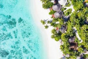 Sea beach aerial. Luxury summer travel vacation landscape. Tropical beach, drone view. Beach villas bungalows of hotel resort. Perfect beach scene vacation, summer holiday template. Wonderful nature photo