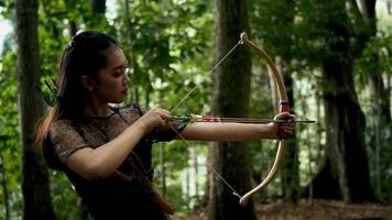 Indonesian Women with black dresses shoot the target with a flying arrow video