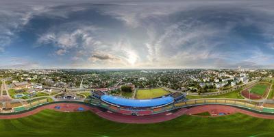 aerial 360 hdri panorama view from above on empty stadium or sports complex in equirectangular seamless spherical projection, ready for use as sky replacement in drone 360 panoramas photo