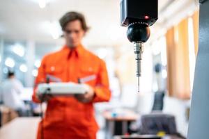 Close-up probe measurement of detail by detecting head sensor at production line in the industry factory. Selective focus photo