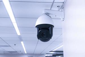 Security CCTV camera or surveillance system in building ,Closed-circuit television,Modern CCTV camera on a wall. photo